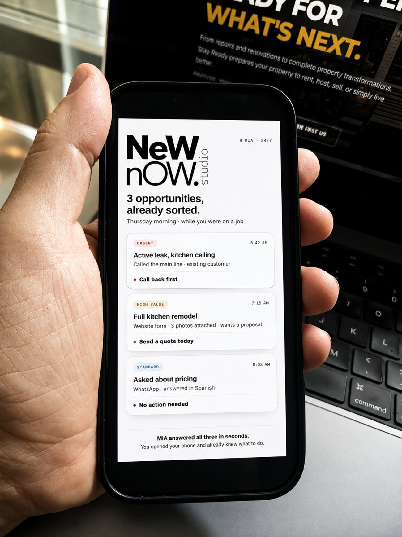 A phone showing opportunities sorted by urgency, held in a workspace